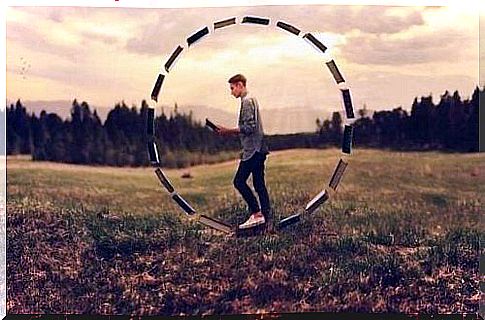 Boy stands in circle of books