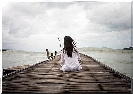 Woman sitting on a pier