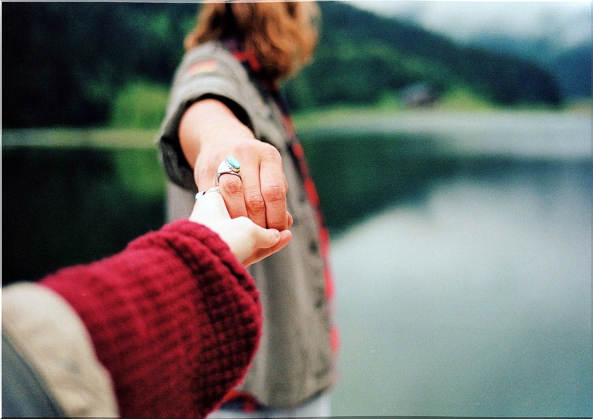 Two hands that let go of each other as a symbol of the emotional distance between people