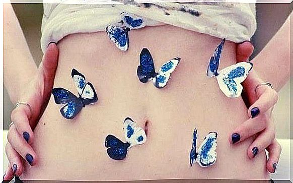 Girl with blue and white butterflies on her belly