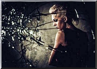 A woman behind broken glass