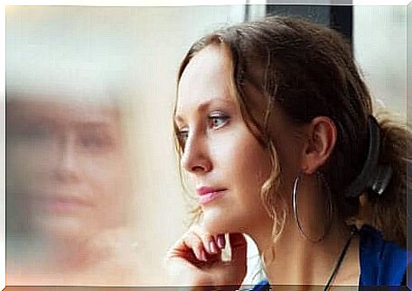 A woman stares out a window