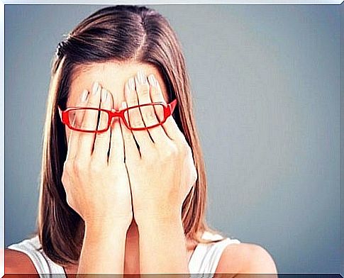 Girl holding her hands under her glasses to protect herself from people who don't have good intentions