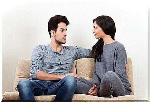 Man and woman talking on the couch