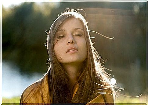 Girl enjoying the sun with eyes closed 