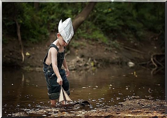 Little Boy Playing Alone With A Boat As An Example Of How Children Suffering From Asperger's Syndrome Are